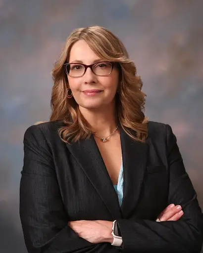 Headshot of Kay Wolff Kripchak founder, principal coach and consultant for Kay Wolff Coaching and Consulting wearing a black blazer with arms crossed